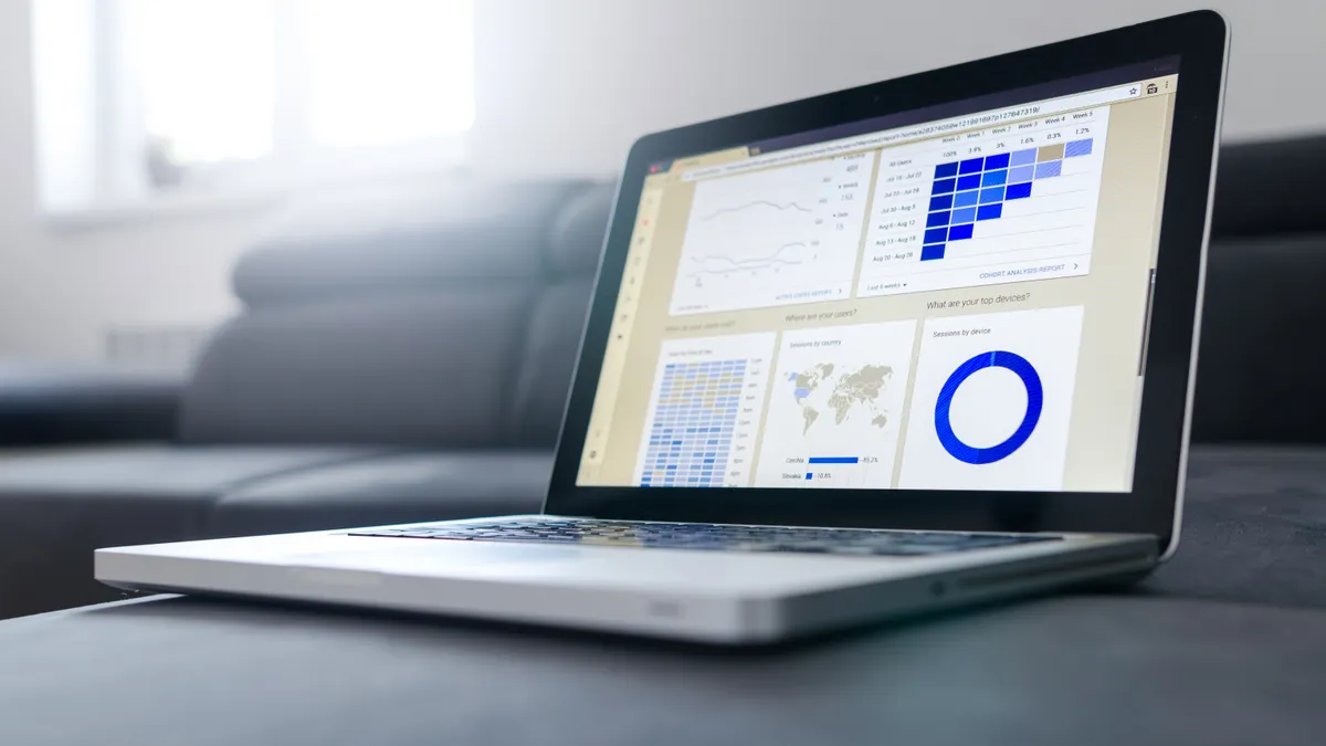 laptop displaying an analytics dashboard with charts