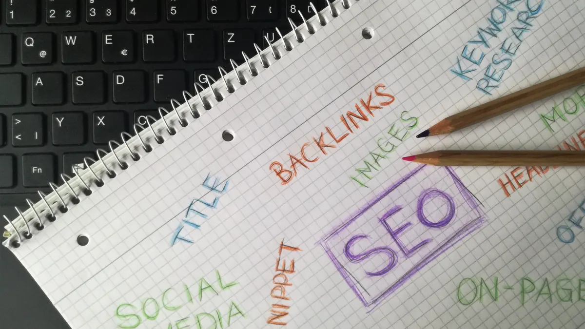 Notebook with SEO-related terms and a pencil