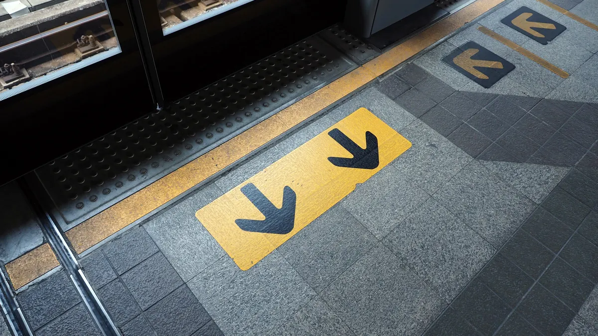 floor arrows directing movement toward an entrance